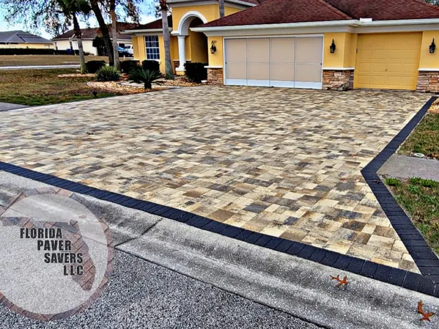 Custom paver driveway with a contrasting charcoal border